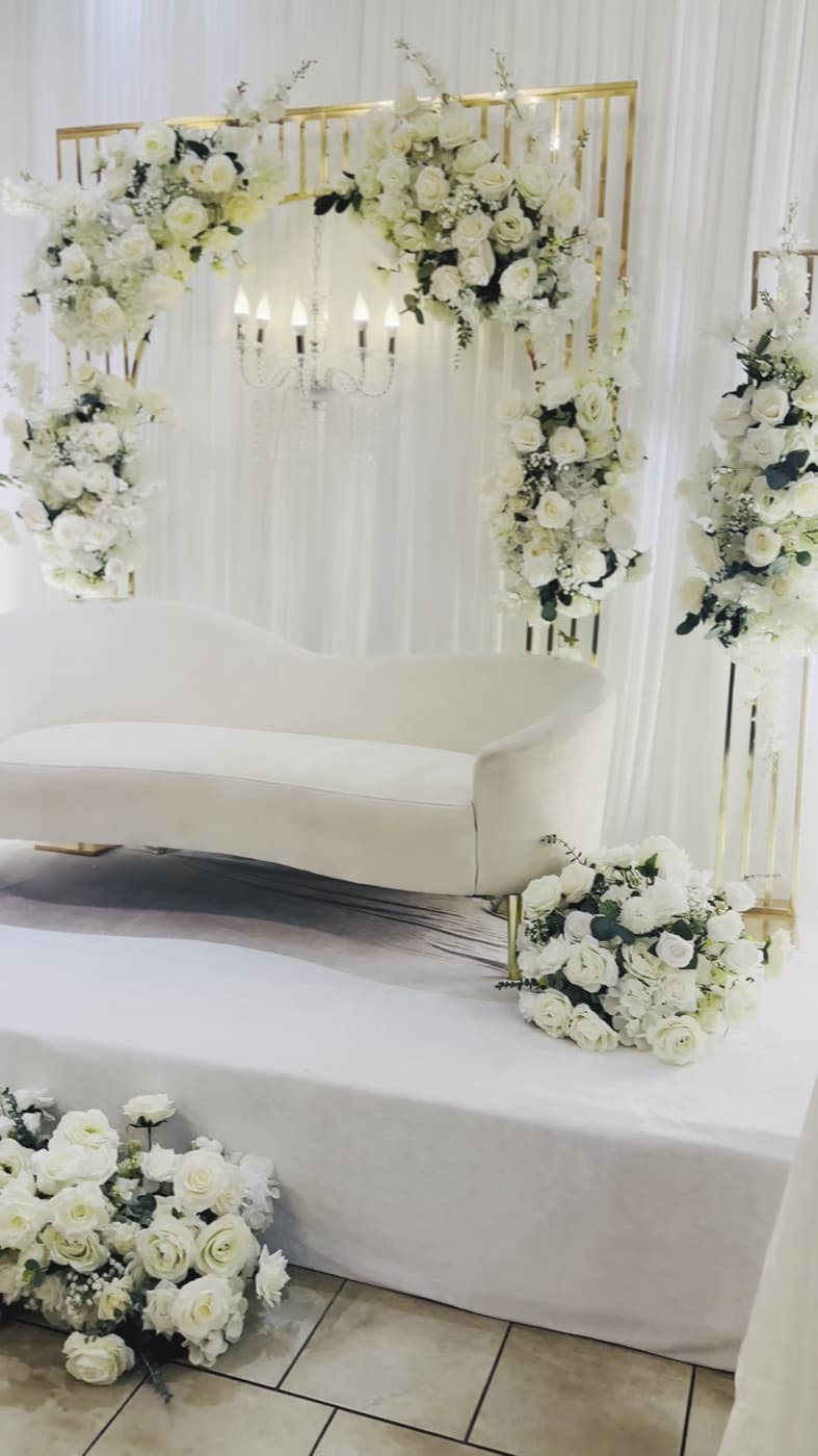 Floral arch and couple's settee